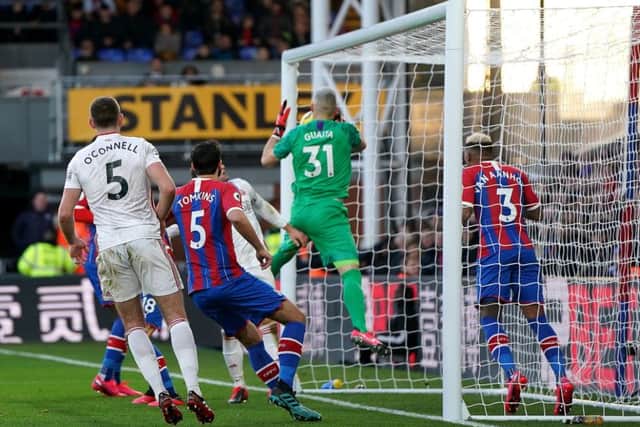 Crystal Palace goalkeeper Vicente Guaita (centre) handles the ball and scores an own goal.