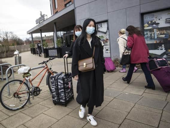 People wearing masks in York after it was confirmed two people who had tested positive for the illness had been staying in the city.