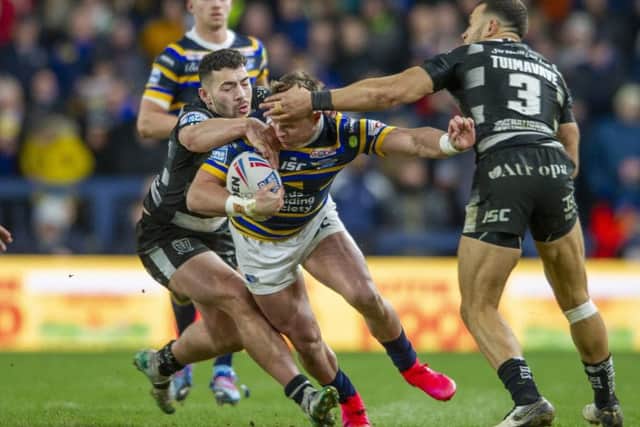 Leeds Rhinos' James Donaldson tackled by Hull's Jake Connor and Carlos Tuimavave. Picture Tony Johnson