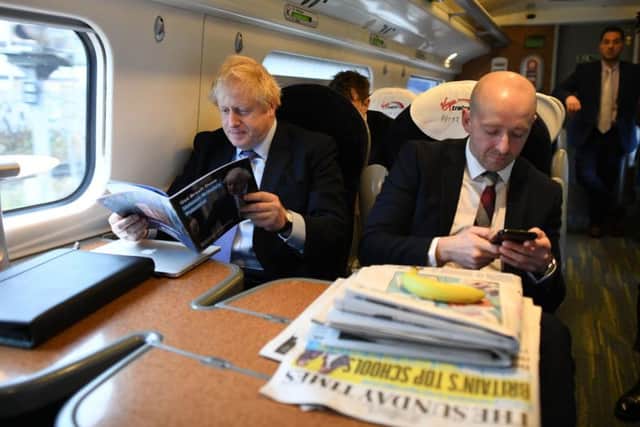 Prime Minister Boris Johnson, sitting with his Director of Communications, Lee Cain (right). Photo: PA