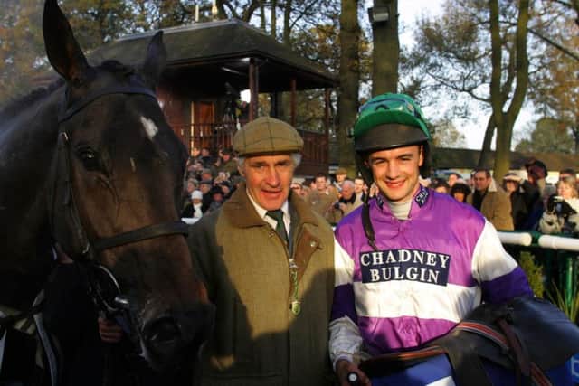 Trainer Robert Alford and his son-in-law Mark Walford celebrate the Betfair Chase win of Kingscliff at Haydock.