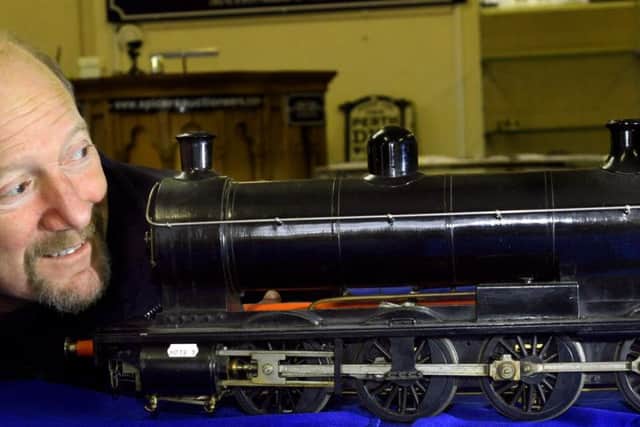 Auctioneer Andy Spicer with a 31/2 inch guage LNER 0-8-0 live steam coal fired Q5 locomotive with a tender, which has a guide price of 800-1200 Picture: Gary Longbottom