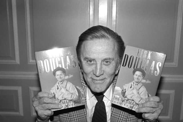 Kirk Douglas with copies of his autobiography The Ragman's Son at Harrods Department Store in 1988. Credit: PA