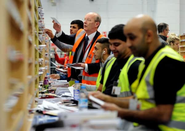 Royal Mail's Stephen Foster helping to sort the incoming mail at Leeds Royal Mail Centre in Stourton. Picture: James Hardisty