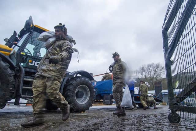 Soldiers from the Highlanders based at Catterick Garrison help build flood defences in Mytholmroyd  in preparation for Storm Dennis.
