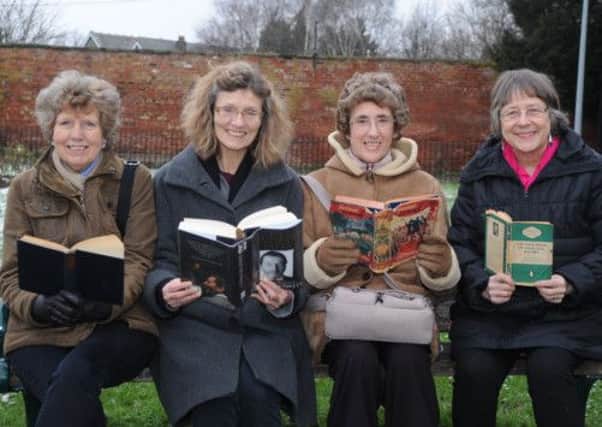Sue Roe, Loveday Herridge, Shirley Ellins and Dr Mary Glover reading in Hillsborough Park near the library