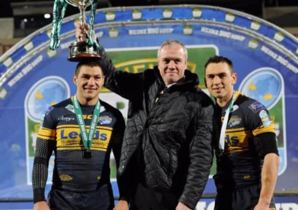 Brian McDermott (centre) has signed a new contract with Super League champions Leeds .