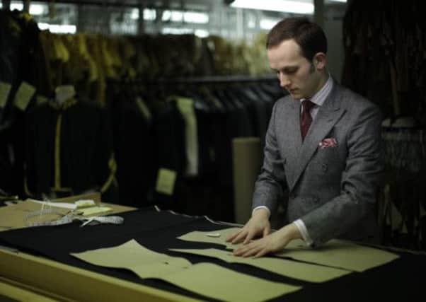 Gieves and Hawkes bespoke under cutter Richard Lawson at the tailor's premises on Saville Row in London