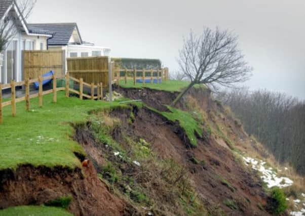 The landslip at Knipe Point has left the properties only inches from the edge of the collapse.