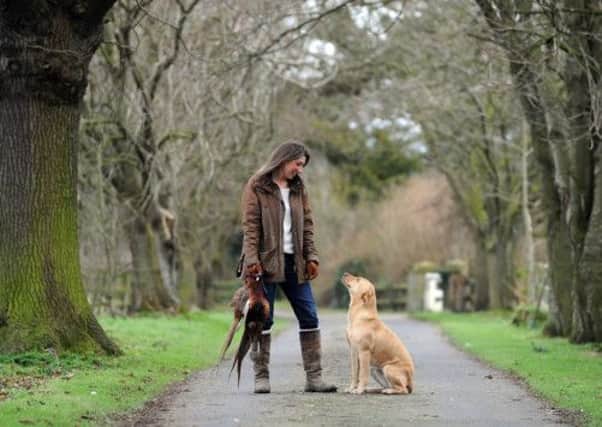 Nicola Dixon with freshly shot pheasent and her dog