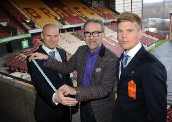 Suit designer Simon  Carter with Bradford City captain Gary Jones and Alan Connell get fitted for their suits at The Coral Windows Stadium