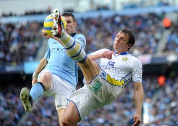 Stephen Warnock battles for the ball with James Milner