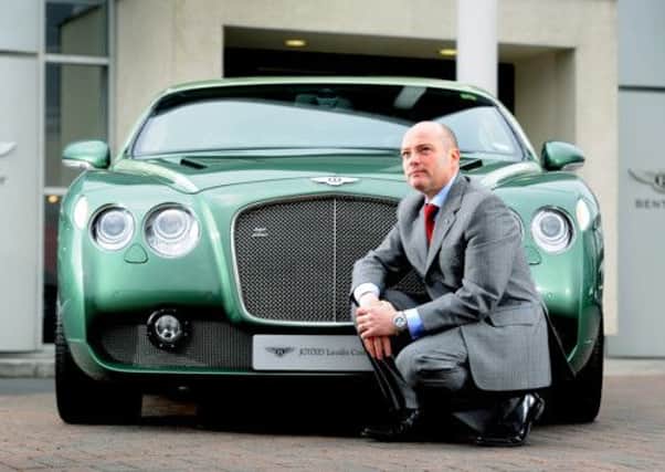 Mark Ballance, sales manager at JCT Leodis Court Bentley, dealership in Leeds, next to a rare Bentley GT Zagato