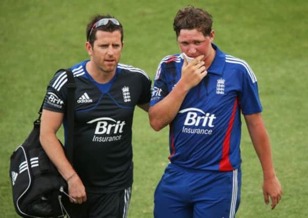 Gary Ballance retires hurt and is helped from the field after being struck in the face