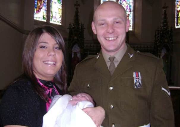 Lance Corporal David Kenneth Wilson with his fiancee Michelle Curry and daughter Poppy.