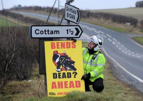 PC Simon Carlisle mounting a warning sign for speeding motorcyclists on the Wolds near Driffield as part of Operation Achilles.