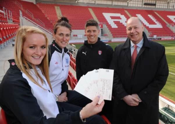 England woman footballers Sophie Bradley, left, and Jill Scott with tickets for their game at Rotherham United's New York ground with Rotherham United player Alex Revell and the club's chief operating officer Paul Douglas. (Picture: Chris Lawton).