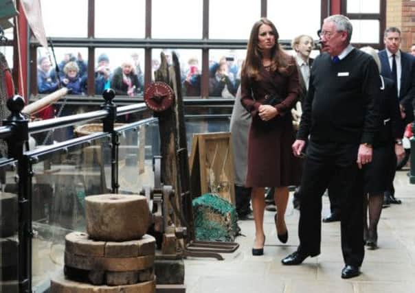 The Duchess of Cambridge talks to former trawler-man John Vincent during her tour of the National Fishing Heritage Centre, Grimsby.