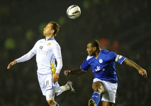 Luke Varney and Wes Morgan rise for a high ball in the Leicester match.