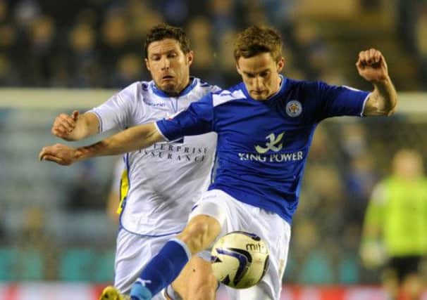 Andy King takes the ball from David Norris in the Leeds-Leicester match