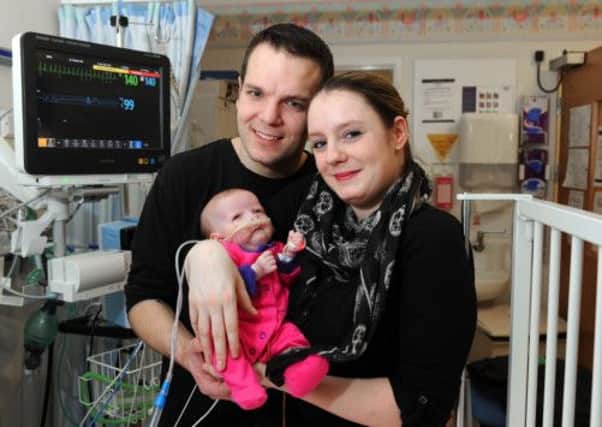 Jamie Newson-Smith and Hannah Reynard with their daughter Ella in the Leeds childrens heart surgery unit