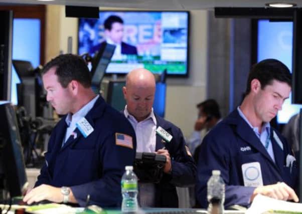 Traders and specialists work on the trading floor of the New York Stock Exchange