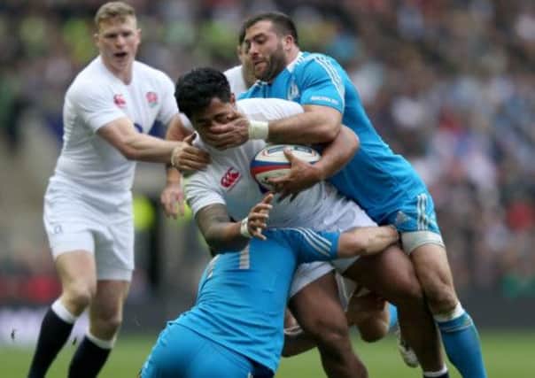 England's Manu Tuilagi is tackled by Italy's Luke McLean and Robert Barbieri