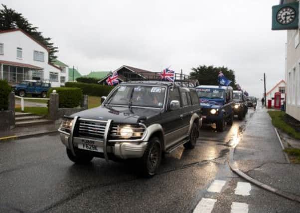 Vehicles bearing British flags and stickers in favor of keeping the Falkland Islands as an overseas territory of the United Kingdom in Port Stanley.