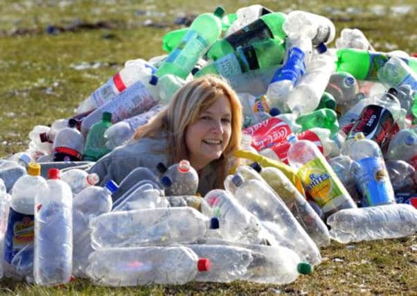 Deb Wright, Project Officer for the Harrogate Flower Show, surrounded by  plastic bottles