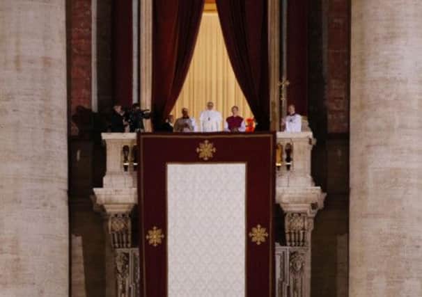 Pope Francis speaks to the crowd from the central balcony of St. Peter's Basilica at the Vatican