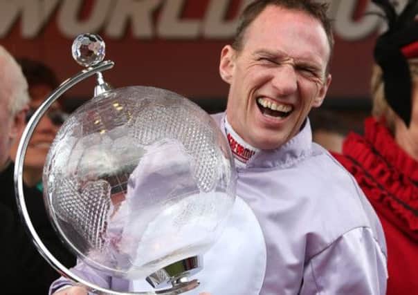 Jockey Paul Carberry celebrates winning the Ladbrokes World Hurdle on Solwhit