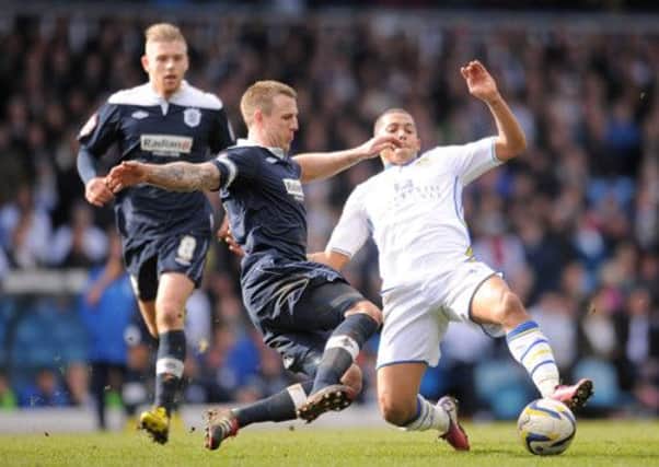 Leeds United's Ryan Hall (right) and Huddersfield Town's Peter Clarke (left) battle for the ball last Saturday