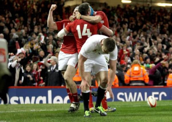 Wales Jonathan Davies leads the celebrations for Alex Cuthberts first try