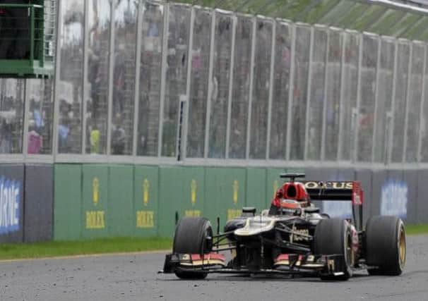 Lotus driver Kimi Raikkonen of Finland crosses the line to win the Australian Formula One Grand Prix