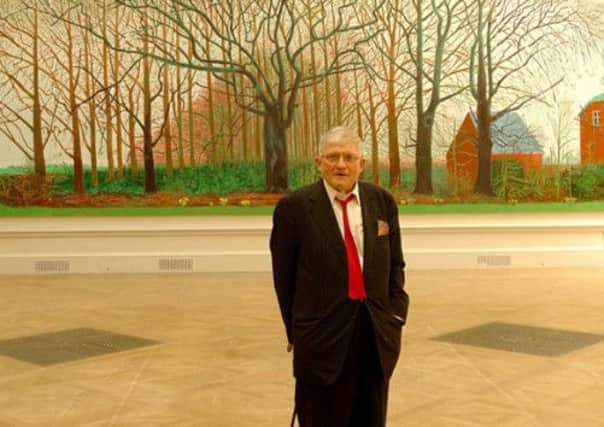 David Hockney in front of his collage of Bridlington views.