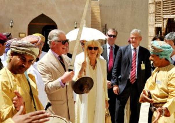 The Prince of Wales is given an Omani sword by a traditional singing group that also dance, while he and the Duchess of Cornwall visit the Nizwa Fort on day two  of their tour of Oman.
