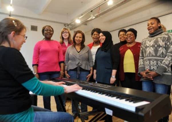 Refugee women from Leeds who have formed a choir rehearsing with conductor   Sophie Jennings (left)    at St Peter's Buildings near to the west Yorkshire Playhouse in Leeds.