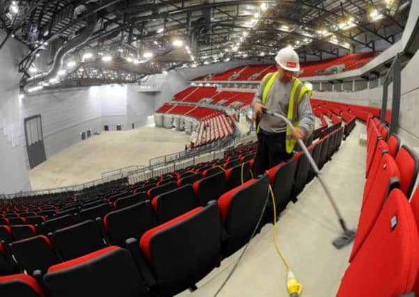 Construction worker Peter Stott cleans the seating area in the Leeds Arena as works nears completion