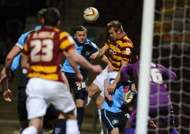 James Hanson heads the ball across to Garry Thompson for the Bantams' opening goal.