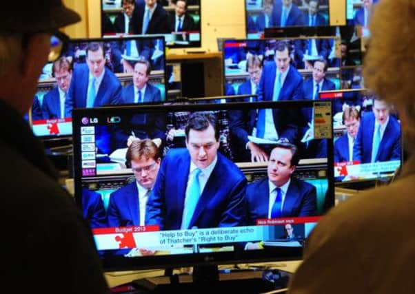 Chancellor of the Exchequer George Osborne seen on TV screens during the Budget