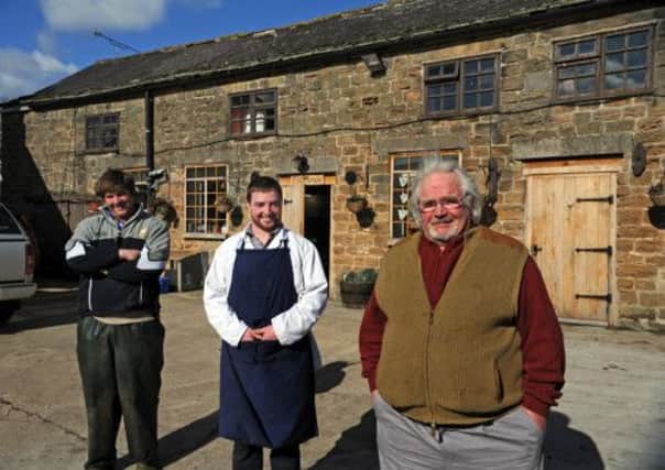 Farmer David Ross outside the farm shop with sons Chris, left and Anthony