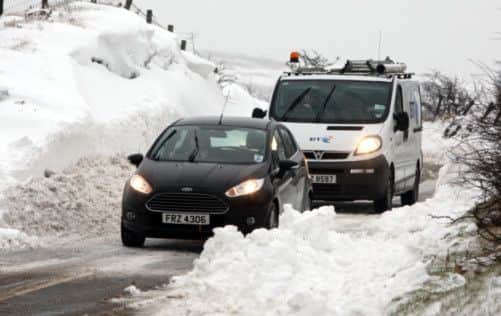 Motorists make their way through snow covered roads