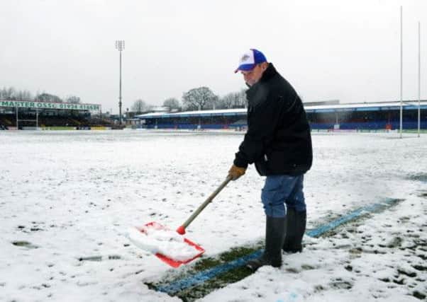 Wakefield Wildcats groundsman Steve Dutton clears the lines on the pitch, after the home game against Leeds Rhinos was called off. PIC: Jonathan Gawthorpe