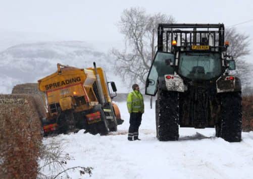 A gritting vehicle waits to be pulled from a ditch near Kippen in Stirlingshire