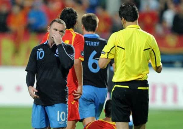 England's Wayne Rooney being sent off after kicking out at Montenegro's Miodrag Dzudovoic in 2011.