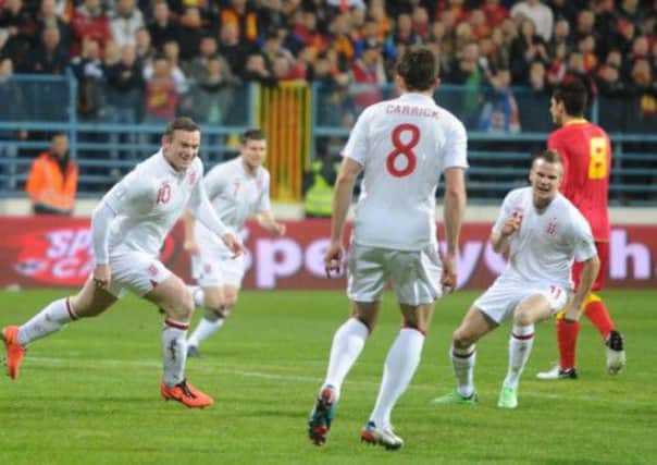 England's Wayne Rooney celebrates his goal during the FIFA World Cup Qualifying, Group H match at the City Stadium, Podgorica, Montenegro.
