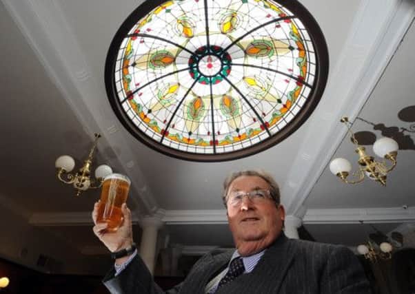Sir William McAlpine enjoys a pint under one of the feature domed windows in the pub.  Picture by Gerard Binks