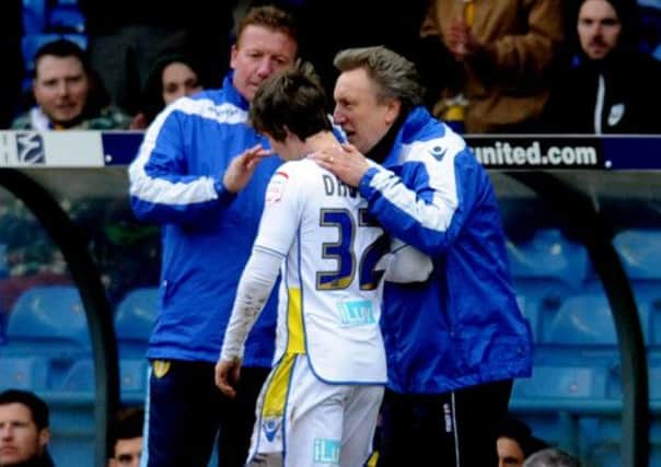 Neil Warnock has a quick chat with Chris Dawson, who leaves the field after making his debut for the club.