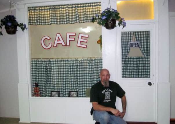 Darin Iscrupe in front of his replica of Sid and Ivy's cafe from Last of the Summer Wine, in Tallahassee, Florida.