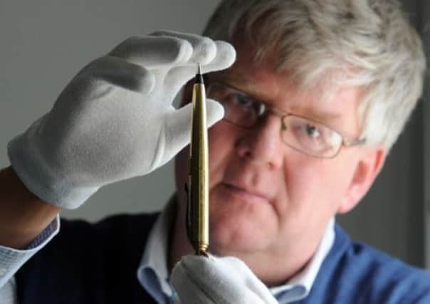 Senior Curator of Firearms Mark Murray-Flutter with the gold plated pen